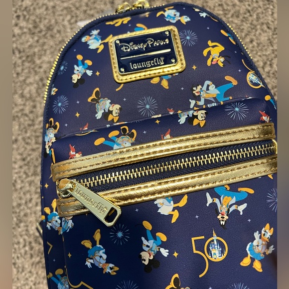 Loungefly Handbags - Loungefly Navy Blue & Gold Disney Parks 50th Mini Backpack new with tag